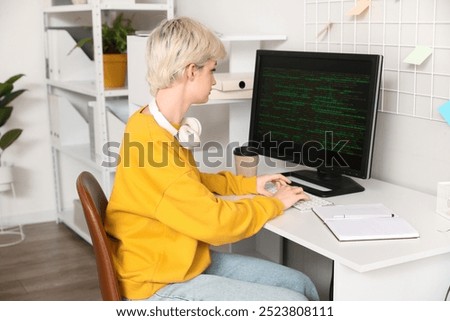 Female programmer working with computer in office