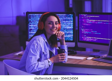 Female programmer working in office at night - Shutterstock ID 2044124504