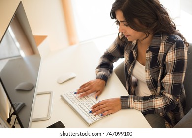 Female Programmer Working On Desktop Computer