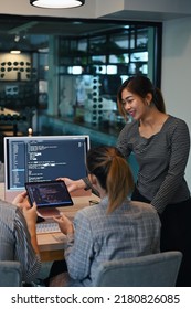 Female project supervisor explaining detail of project developing website design and coding technologies at creative office - Shutterstock ID 2180826085