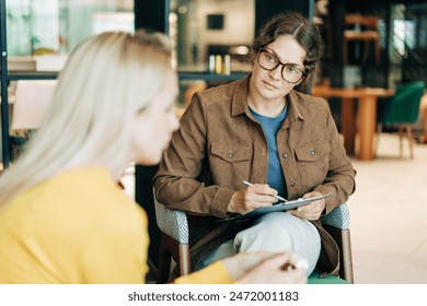 A female psychologist is counseling a depressed client. Working woman, professional specialist. - Powered by Shutterstock