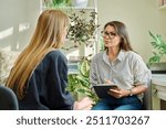 Female psychologist having therapy session with young woman