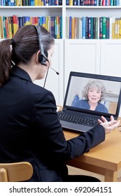 Female Psychologist With Headset In Her Office In Front Of Her Computer, Talking To A Senior Woman During A Live Video Call Or Chat, Online Counseling Session Template