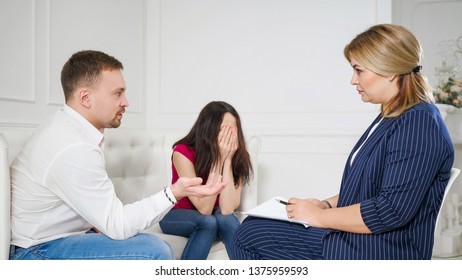 Female Psychologist Helping Worried Young Couple. Family Therapy. Angry People