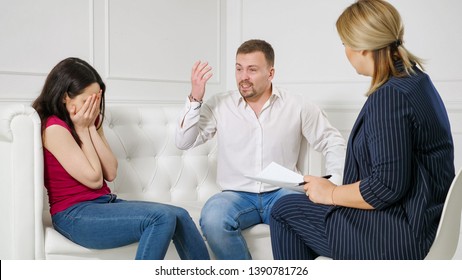 Female Psychologist Helping Worried Young Couple. Family Therapy. Angry People