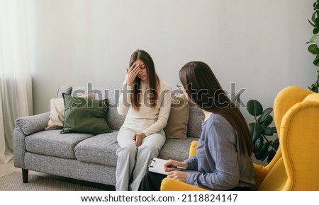 a female psychologist provides psychological assistance to a distressed female patient. Domestic violence. Depression