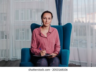 A Female Psychologist Is Sitting On A Chair In The Room