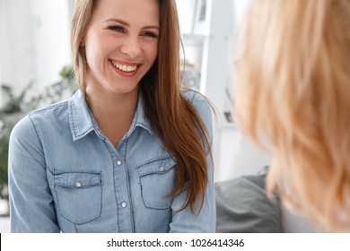Female psychologyst therapy session with client indoors sitting patient smiling cheerful close-up