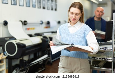 Female Publishing Facility Manager Reading Operation Manual For Large Printer.