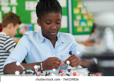 Female Pupil Using Molecular Model Kit In Science Lesson - Powered by Shutterstock