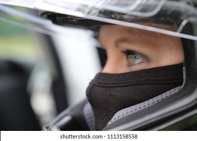 Female Race Car Driver Wearing Helmet And Balaclava