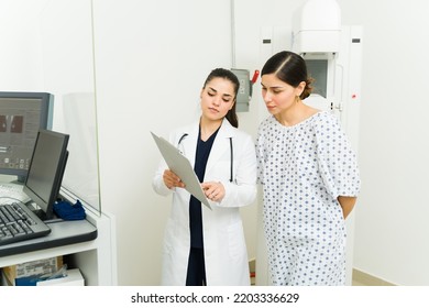 Female Radiologist Giving The Medical Results Of The Mammogram X-ray Exam To A Young Woman At The Hospital 