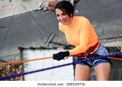 A Female Rappellist Descending The Elevator Lacerates. Very Tall Monument. Salvador Bahia Brazil.