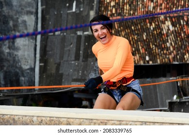 A Female Rappellist Descending The Elevator Lacerates. Very Tall Monument. Salvador Bahia Brazil.