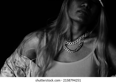 Female Rapper With Eyes Closed In Front Of Black Background