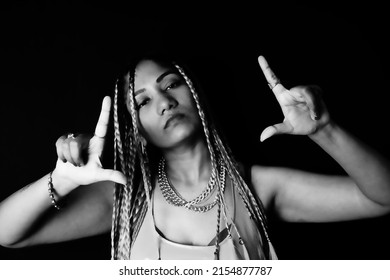 Female Rapper Gesturing Over Black Background