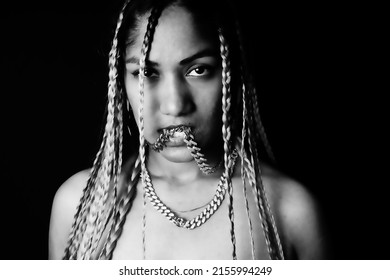 Female Rapper Wearing Braids In Front Of Black Background