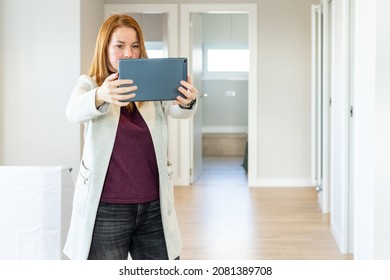 Female Real Estate Agent Conducting A Virtual Tour Of A New Property To Show It To Clients. High Quality Photo