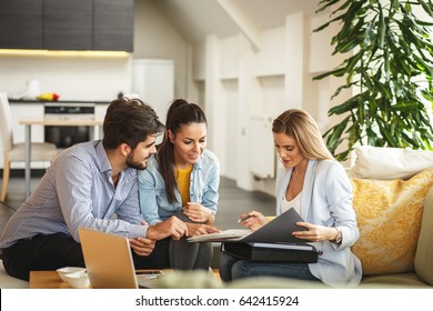 Female Real Estate agent offer home ownership and life insurance to young couple. - Shutterstock ID 642415924