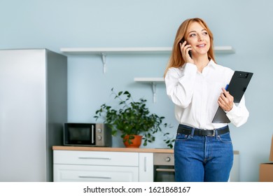 Female Real Estate Agent Talking By Mobile Phone Indoors