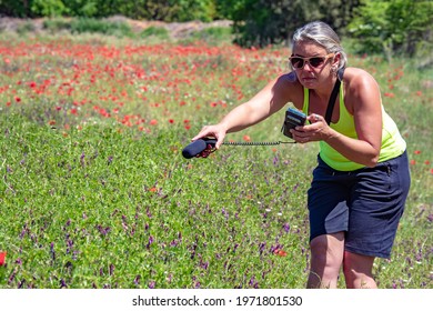 Female Recording Audio Sound Of The Bees In Flower Field For Video