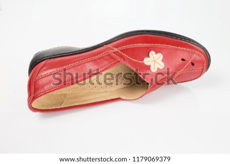 Female red leather shoe on white background, isolated product, comfortable footwear.