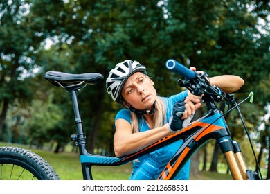 Female Replacing Cycle Handle Grip. Sporty Mature Woman Cyclist Fixing Her Bike Brakes Outdoor