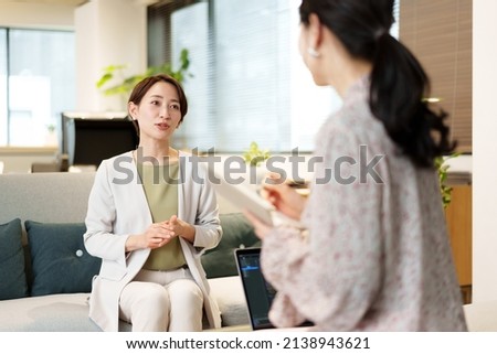 female reporter interviewing businesswoman in a office