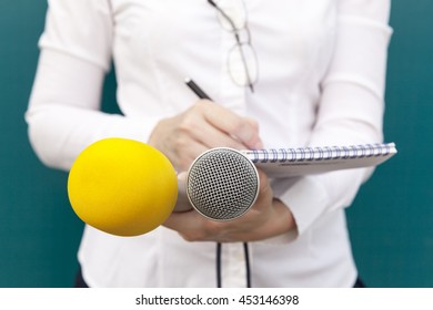 Female Reporter Or Journalist At News Conference, Writing Notes, Holding Microphones