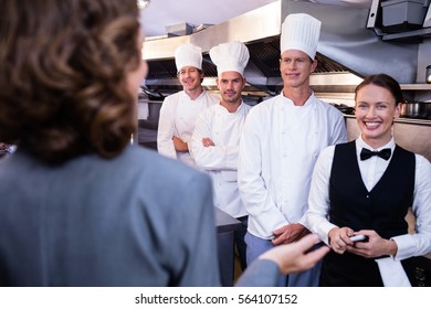 Female Restaurant Manager Briefing To His Kitchen Staff In The Commercial Kitchen