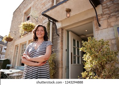 Female Restaurant Pub Owner Standing Outside Her Business