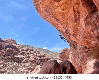 Female rock climber rock climbing at red rock canyon on a sunny day - Powered by Shutterstock