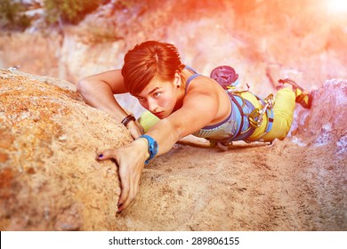 female rock climber climbs on a rocky wall. Geyikbayiri, Turkey.