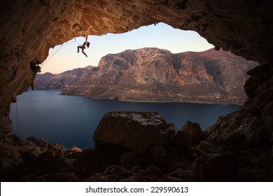 Female rock climber on a cliff in a cave at Kalymnos, Greece