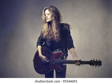 Female Rock Star Playing The Guitar