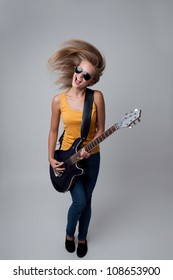 Female Rockstar Playing Guitar. Isolated.