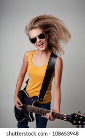 Female Rockstar Playing Guitar. Isolated.