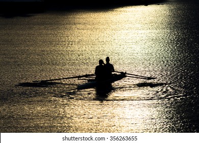 Female Rowers In A Double Scull On Sunset Lake