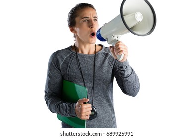 Female rugby coach announcing on megaphone while standing against white background - Powered by Shutterstock