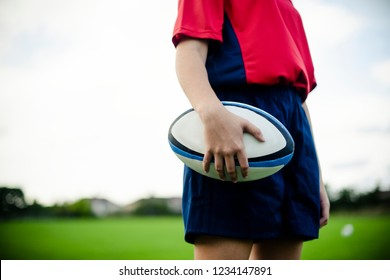 Female rugby player with a ball - Powered by Shutterstock