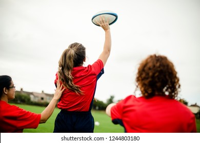 Female Rugby Player Throwing A Ball