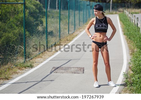 Similar – Frau in Sportbekleidung mit Kopfhörern, die wie ein Smartphone aussehen.