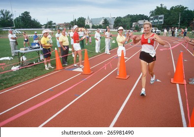 A Female Runner Crossing The Finish Line At The Senior Olympics, St. Louis, MO