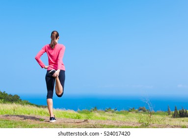 Female Runner Doing A Lower Hamstring Stretch. Warming Up Before Run Concept. 