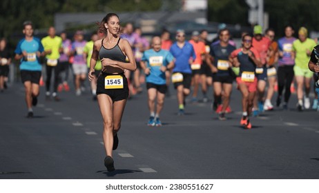 Female runner jog sport marathon. Woman athlete run long distance. Girl jogger work out urban public park. Sportswoman train body. Health city life concept. Fast run race slow motion. Active fit track