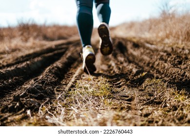 Female Runner Jogging Down An Outdoor Trail At Sunset. New Start Of The New Year 2023, Goals And Plans For The Next Year. Starting To New Year