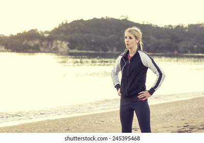 Female runner listening to music while getting ready for a run