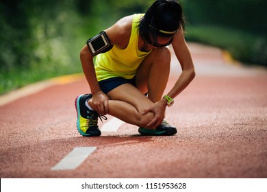 Female Runner Suffering With Pain On Sports Running Knee Injury 
