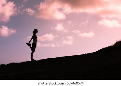 Female Runner Warming Up Before Run