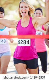 Female Runner Winning Marathon